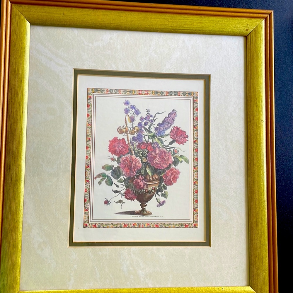 Framed picture of flowers in vase.